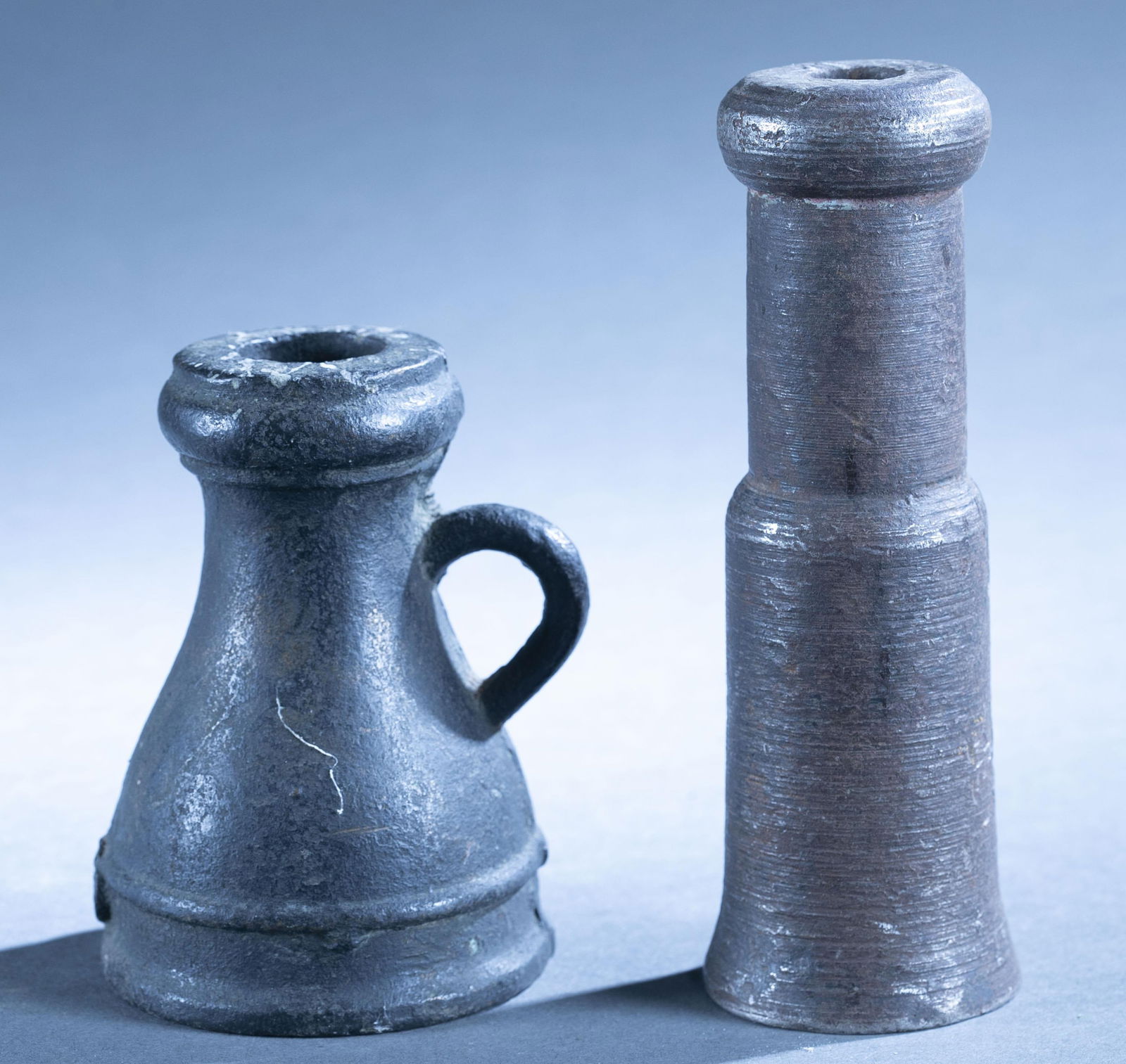 2 Spanish Colonial signaling cannons: A group of three Spanish Colonial signaling, saluting, or powder testers cannon cannons, 17th Century. ++ Bronze "Thunder Mug" type. 5" x 3 1/2" with 28mm bore. ++ Iron tall cylindrical cannon. 7 1/2"