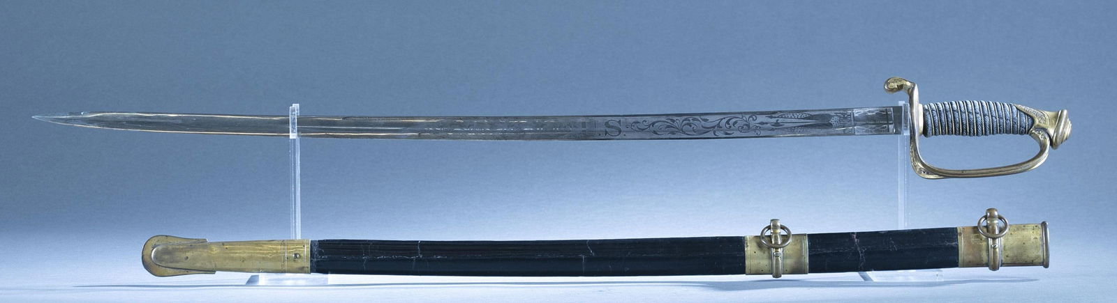 Civil War U.S. Collins M1850 Foot Officer's sword: A Civil War U.S. Model 1850 foot officer's sword and scabbard by Collins and Co, CT. 32" blade with etched martial symbols. Ricasso marked "COLLINS & CO/ HARTFORD/ CONN./ 1862." Gilt brass with pierce