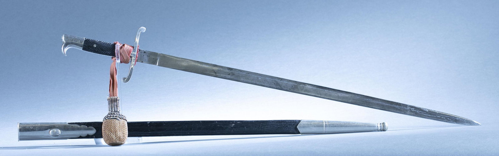 Bavarian WKC police sword with scabbard: A Bavaria police sword with scabbard and sword knot by WKC Solingen, Circa 1920-30s. 23" double edged blade with motto "In Treue fest" on obverse and reverse. Ricasso marked with WKC helmet. Nickel pl