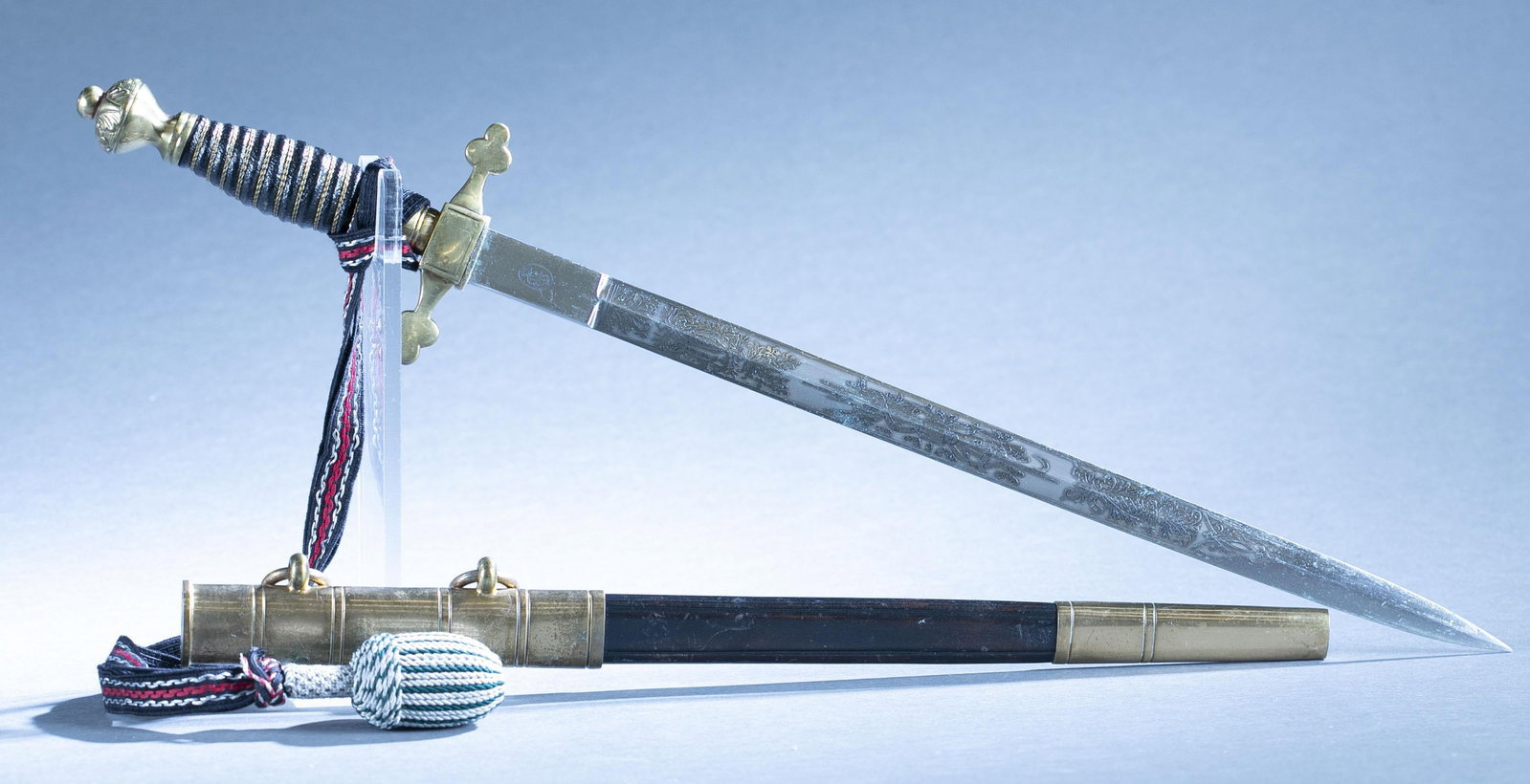 Weimar Republic Fire Brigade Officer's dagger: A Weimar Republic Feuerwehr Dolch Fire Brigade Officer's dress dagger with scabbard and knot by Carl Eickhron, Solingen. 13 1/2" blade with acid etched design of fire fighting equipment. Gilt bronze c
