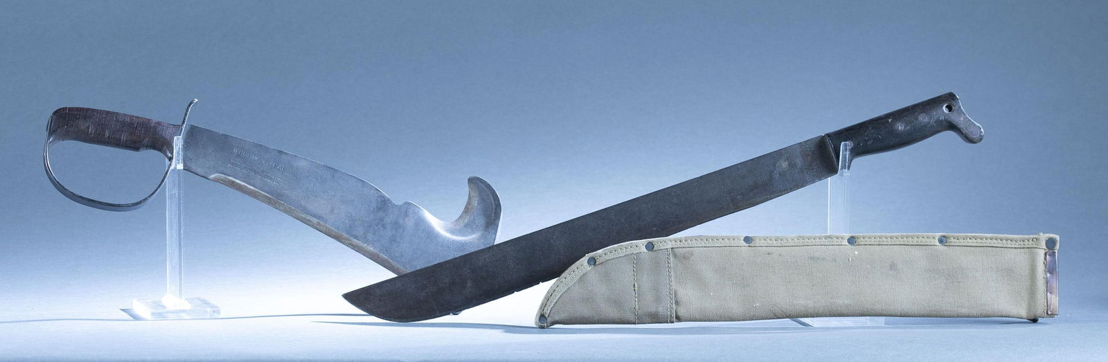 2 WWII U.S. machetes: A group of two WWII U.S. machetes ++ Victor Tool Co. "Woodsman Pal" 280 machete. 12" multi tool blade. 16 1/2" overall. ++ U.S.M.C. Legitimus Collins & Co. No. 37 machete with U.S.M.C. canvas scabbard