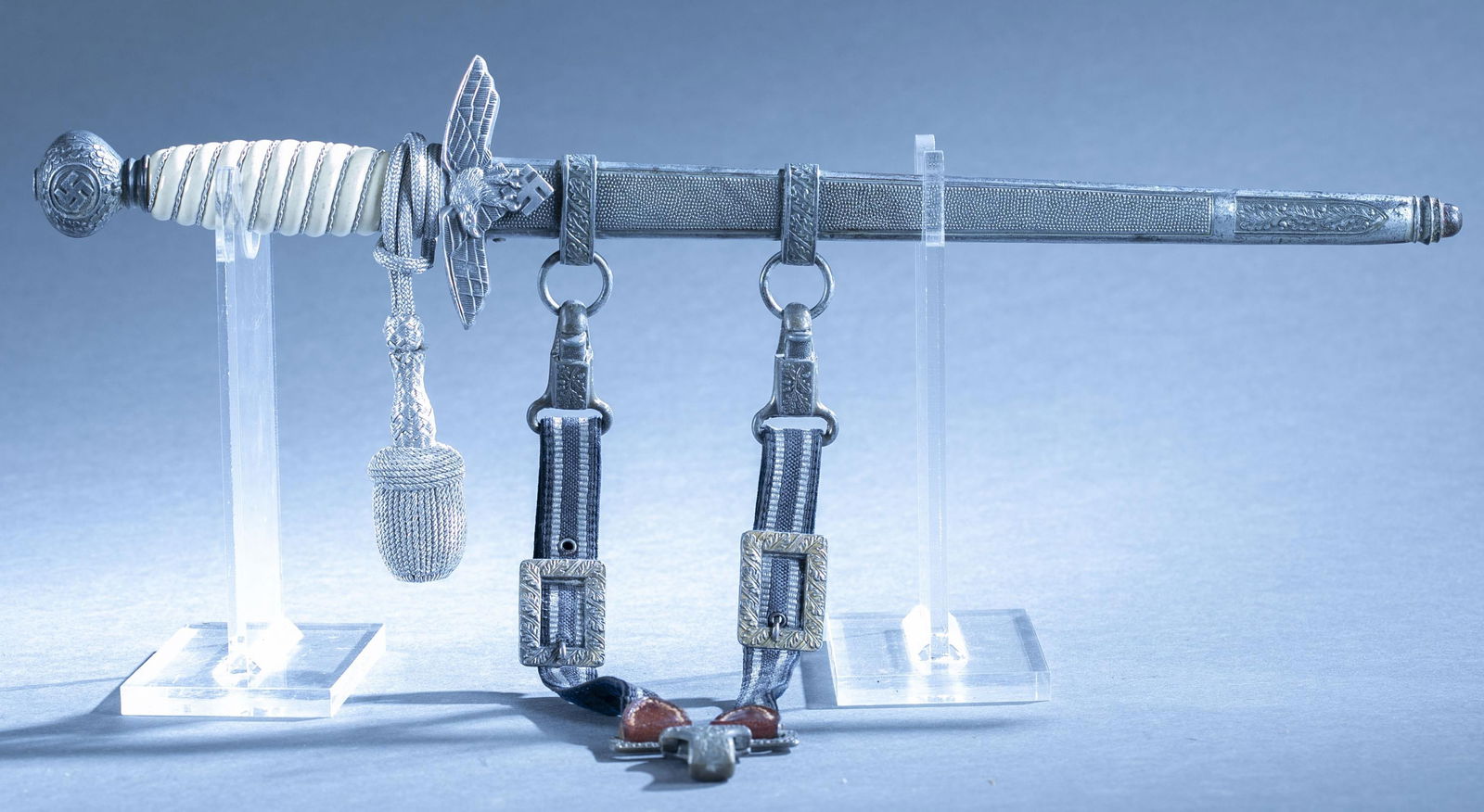 WWII German complete Luftwaffe 2nd Model dagger: A complete WWII German Luftwaffe 2nd Model dagger with scabbard with knot and hanger. 10" double edged blade. Blade unmarked. Aluminum crossguard and silvered pommel. Bakelight corded grip. Silvered s