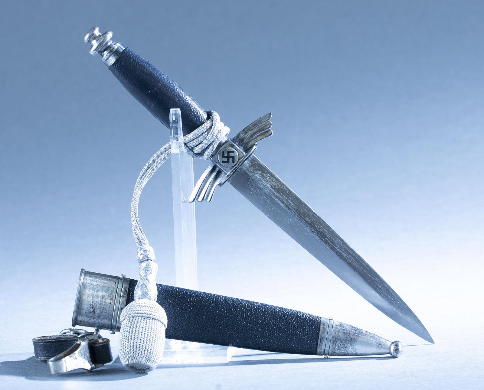 WWII German DLV (NSFK) dagger with scabbard: A WWII German DLV (NSFK) Deutscher Luftsport Verband dagger with scabbard, hanger, and knot by Rich. Plumacher Sohn, Solingen. 7" double edged blade. Ricasso maker marked. Nickel silver hilt with blac