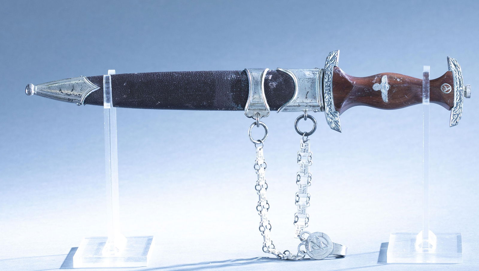 WWII German M1933 SA Damascus Honor Dagger: A WWII German Model 1933 SA Honor Dagger with scabbard and hanger by Rich Plumacher Sohn, Solingen. 8 3/4" Damascus Steel double edged blade. Marked on raised gold "Alles fur Deutschland" flanked by o