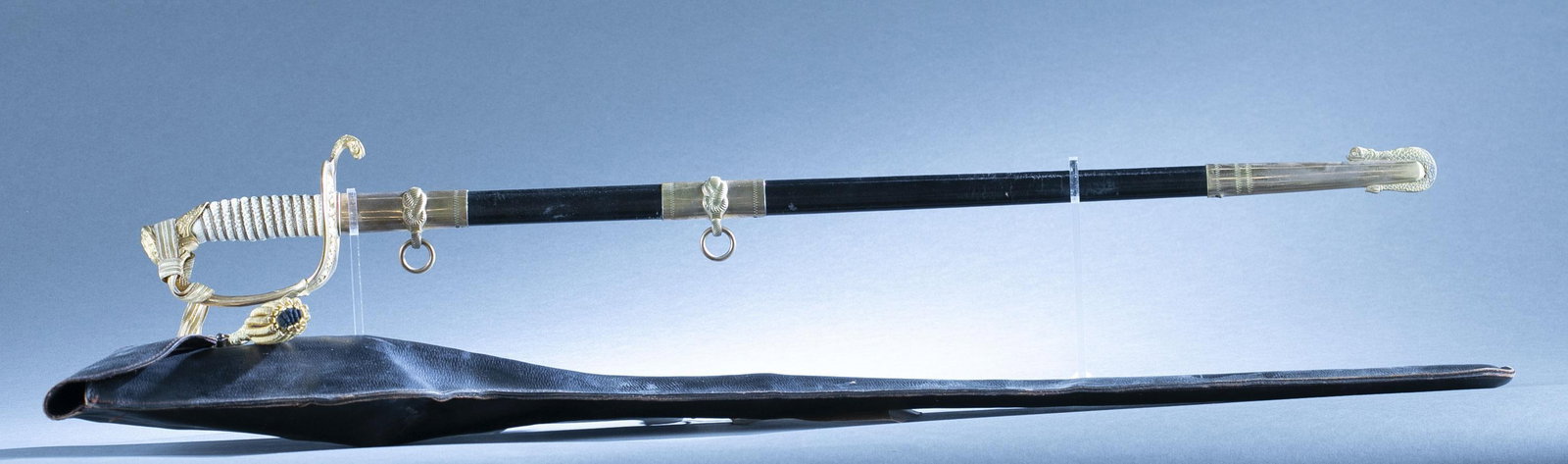 U.S. M1852 Naval Officer's sword and scabbard: An U.S. Model 1852 Naval Officer's sword, scabbard, knots, and leather bag by Hilborn Hamburger Inc. Named to Captain Thomas W. Turner (1942-2023). 28 1/2" single edged blade. 34" overall. 29 3/8" sca