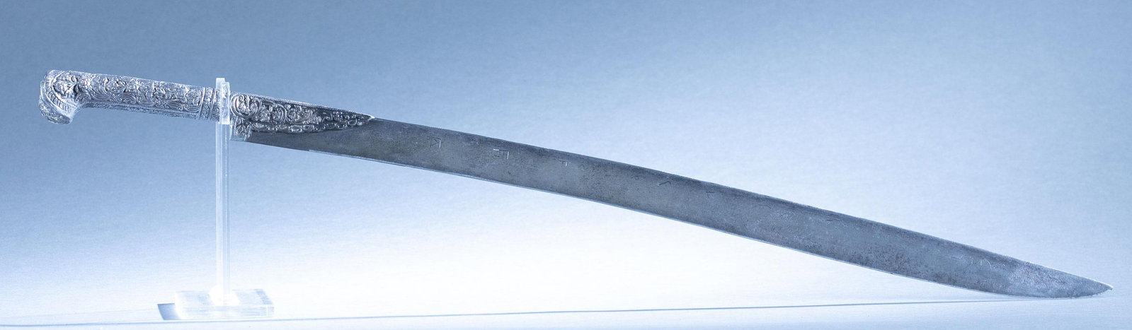 Ottoman Empire Yataghan sword: An Ottoman Empire Yataghan silver mounted sword, 19th Century. 25 1/4" blade decorated with geometric design and Persian-Arabic script. Silver mounted handle with floral design. 30 1/2"