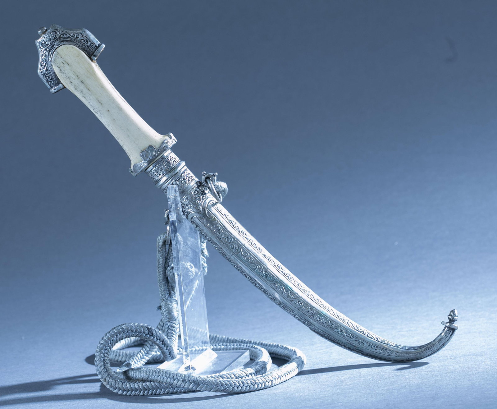Moroccan Koummya dagger with scabbard.: A Moroccan Koummya dagger with scabbard. 9 1/2" double edged blade. Signed on ricasso. Bone and silver mounted handle. Silver chased scabbard. 15" overall. 10 1/4" scabbard.