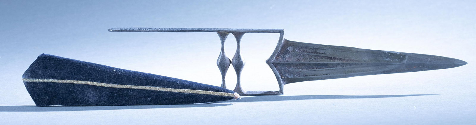 Indian silver damascened Katar dagger: A Indian Katar Jamadhar dagger with scabbard, 19th Century. 8" double edged blade. Silver foliate damascened cross and hand guard. Felt and gold thread scabbard.16" overall. Condition: Rust on blade.