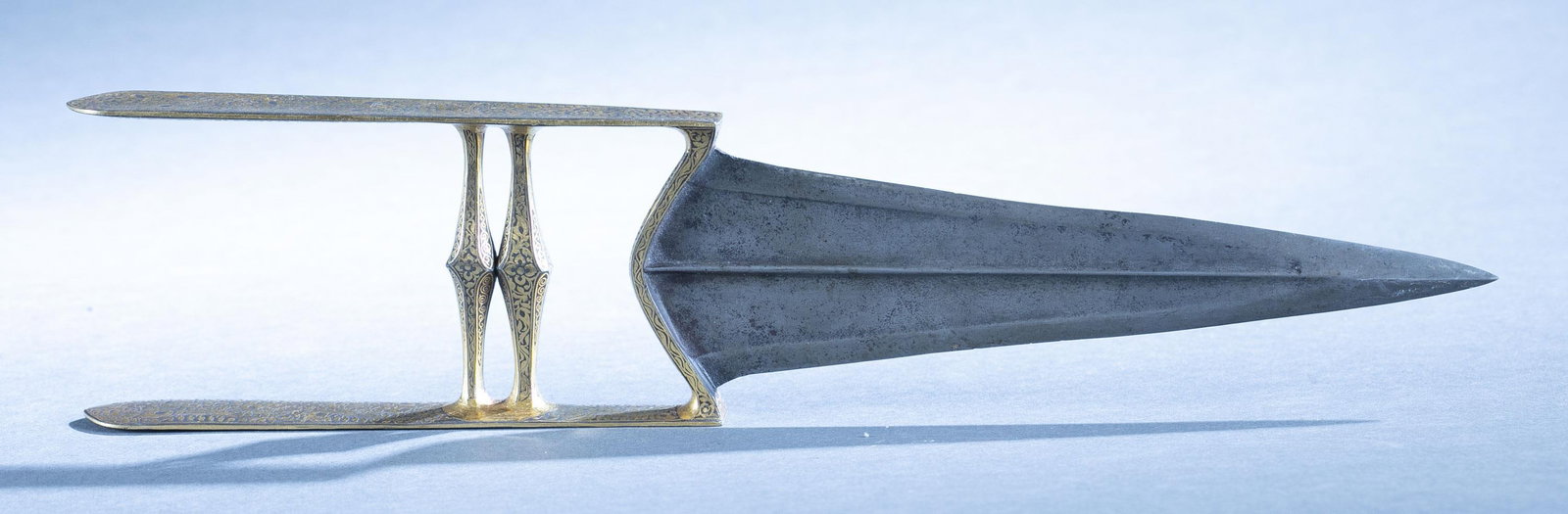 Indian gold damascened Katar dagger: A Indian Katar Jamadhar dagger with scabbard, 19th Century. 7 1/4" Wootz (Damascus Steel) double edged blade. Gold peacock feather and floral damascened grip and hand guard. 13 1/2" overall. Condition