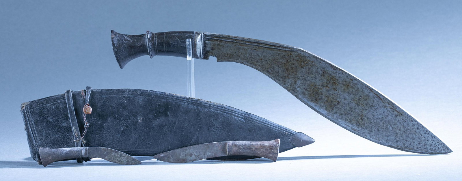 Napalese Kukri knife with sheath: A Napalese Kukri Khukuri knife with sheath. 14 1/2" broad leaf blade. Signed on spine. Wood grip. Leather scabbard. Includes Karda and Chakmak knives. 19 1/2" overall. 15" scabbard
