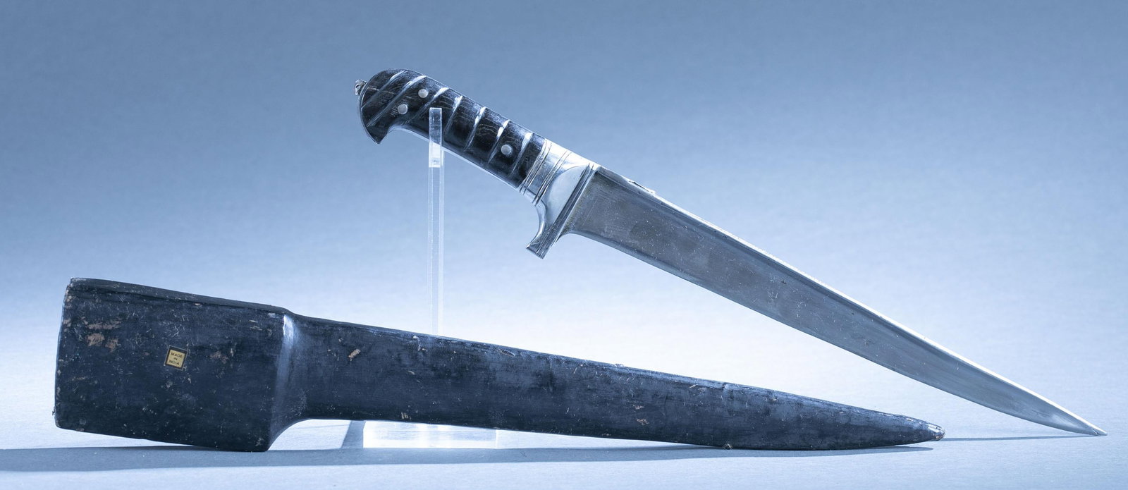 Afghan Kyber Salawar sword and scabbard: An Afghan Kyber Salawar sword and scabbard, 20th Century. 11" single edged blade. Horn grips. Leather bound wood scabbard with "MADE IN INDIA" label. 16" overall. 17" scabbard.