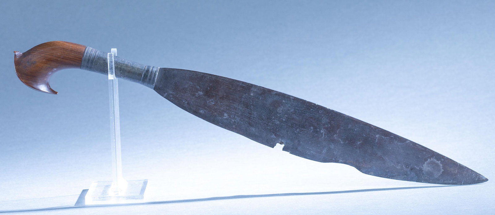 Filipino Moro barong sword: A Filipino Moro barong barung sword. 15" broad leaf single edged blade. Silver ferrule with wood pommel. 21 1/4" Condition: Loss along along edge. Projectile impacted and embedded in edge of blade.