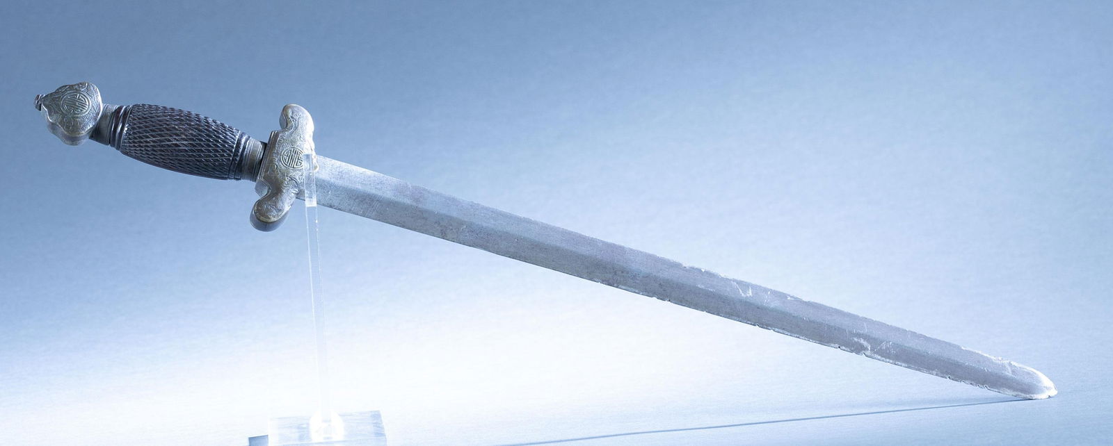 Single Chinese Shuang Jian twin sword: A single Chinese Shuang Jian twin sword, 19th Century. 17" double edged. Bronze crossguard and pommel. Checkered wood grip. 23" overall. Condition: Heavy damage to edge of blade.