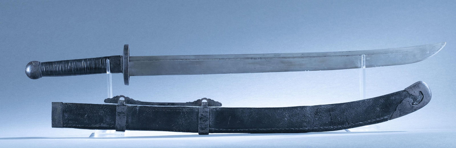 Chinese Qing Yaodao Peidao saber with scabbard: A Chinese Qing Dynasty Yaodao Peidao dao saber with scabbard, 19th century. 27 1/2" straight single edged blade. Cupped iron crossguard, leather cord wrapped grip, and round iron pommel. Leather on wo