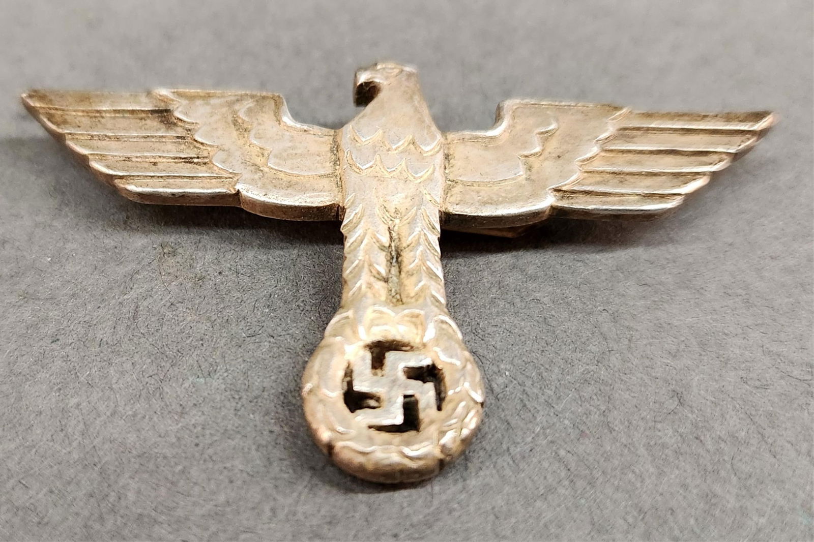 WWII German silvered Reichsadler cap pin: A WWII German silvered Reichsadler cap pin. Three prong fastener. 50mm x 30mm