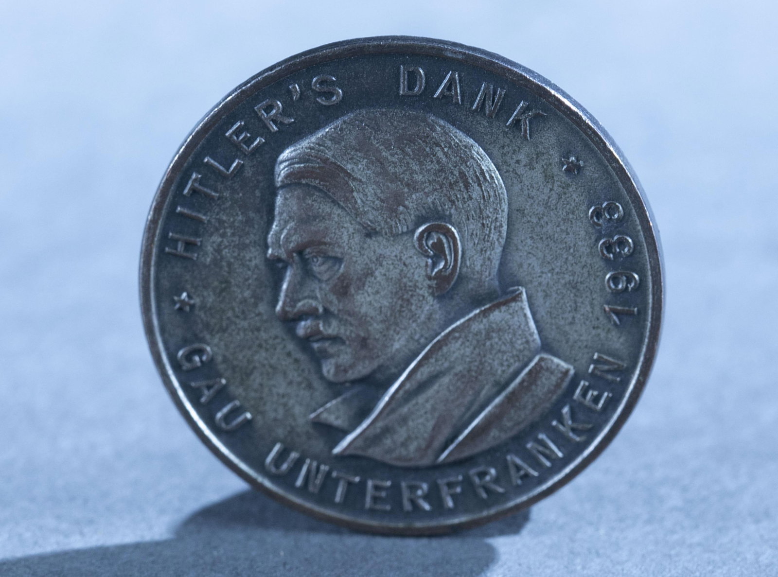 1933 Hitler's Dank tinnie pin: A 1933 Hitler's Dank Gau Main Franconia tinnie pin by Paulmann & Crone. Maker marked on verso. 1 3/4"