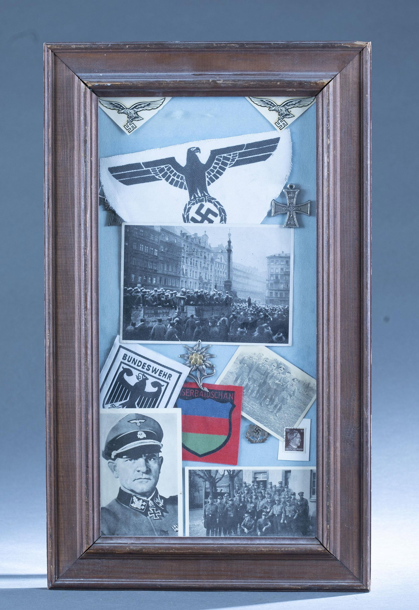 Framed WWII German photographs and medals: A framed group of WWII German photographs and medals. Including a Cross of Honor of the German Mother medal and section of sports shirt patch. 21 1/2" x 13"
