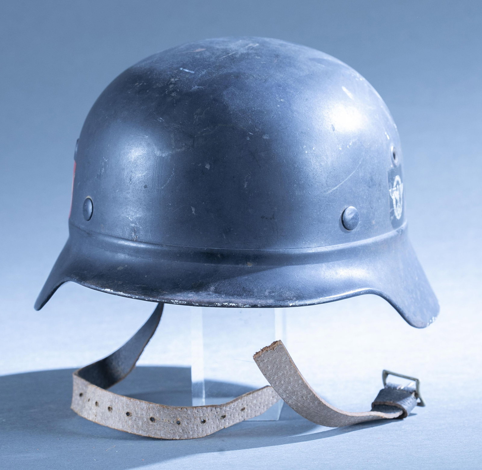 WWII German Polizei M35 beaded helmet: A WWII German Polizei M35 beaded hell helmet. M31 hybrid liner. Stamped "D139" and "NS68." Red NSDAP flag decal and black eagle decal. 7" x 11 1/2" x 9 1/4" Condition: Broken strap.