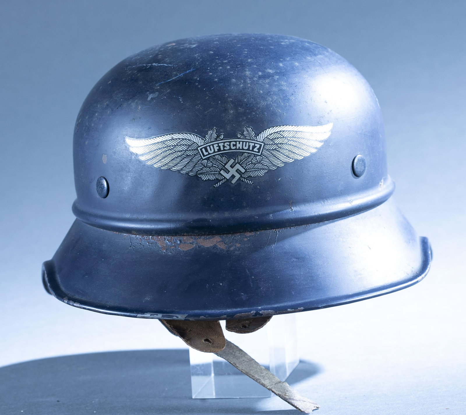 WWII German Luftschutz M34 helmet: A WWII German Reichsluftschutzbund Model 34 Gladiator 3 piece helmet. Luftschutz front decal. Interior label "Vertrieb genehmigt/ gemab 8 Luftschutzgesetz/ Kopfweite 59/ Hochstpreis RM 8." 6 1/2" x 11