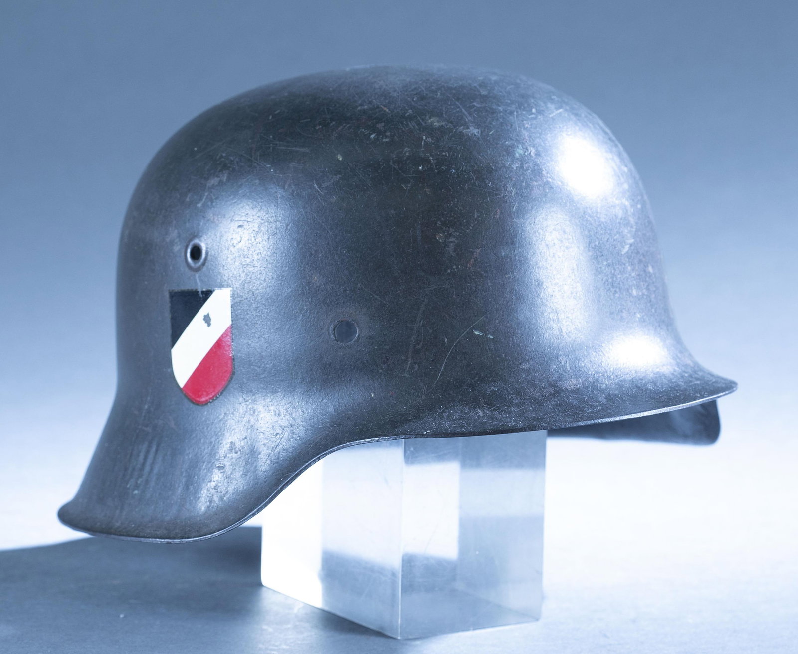 WWII German M42 helmet shell: A WWII German Model 42 helmet shell. Decals added. Stamped inside "C***6/ 3755." Decals not original. 7" x 11 3/4" x 9 1/2"