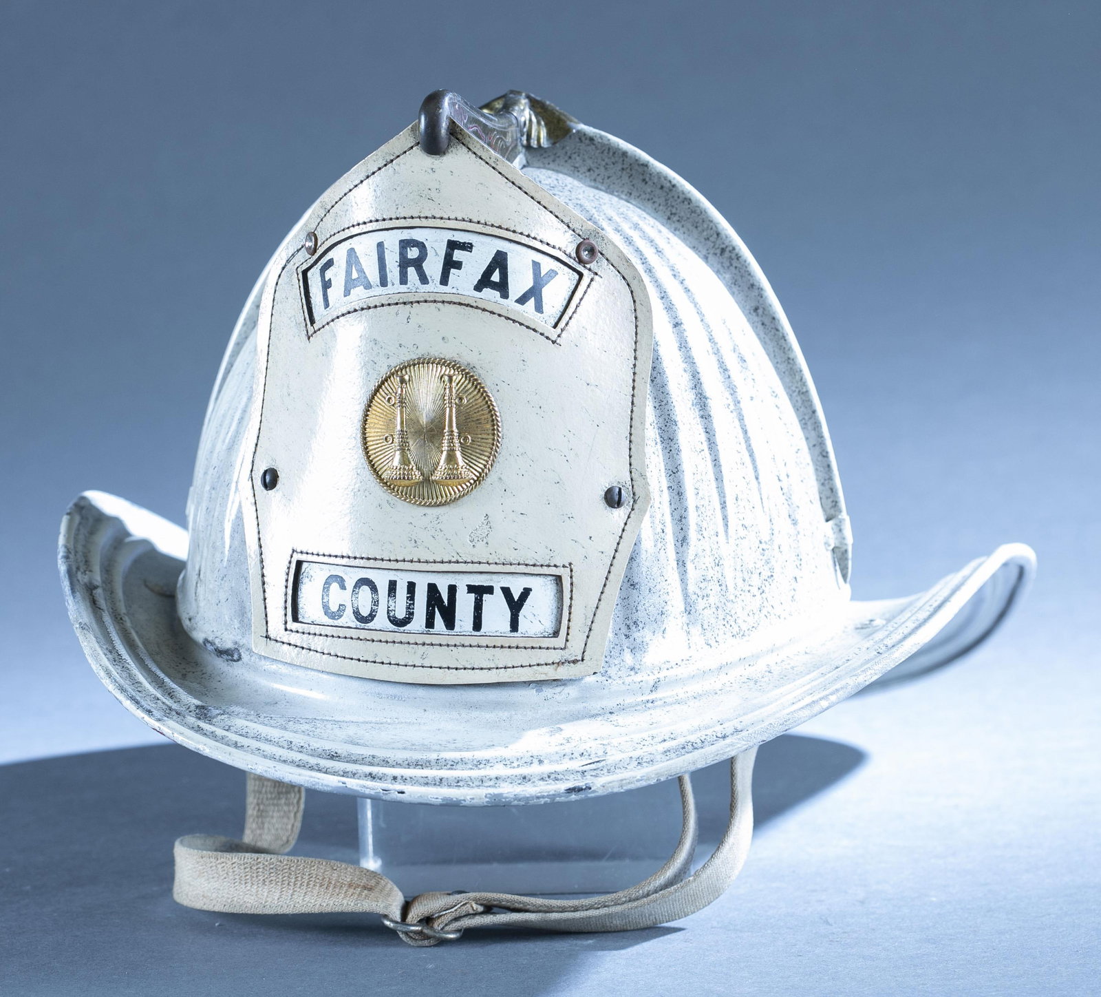 Fairfax VA vintage metal firefighter helmet: A Cairns and Brothers Fairfax VA vintage metal firefighter helmet, Circa 1970s. Fairfax County shield. 7" x 16" x" x 12"