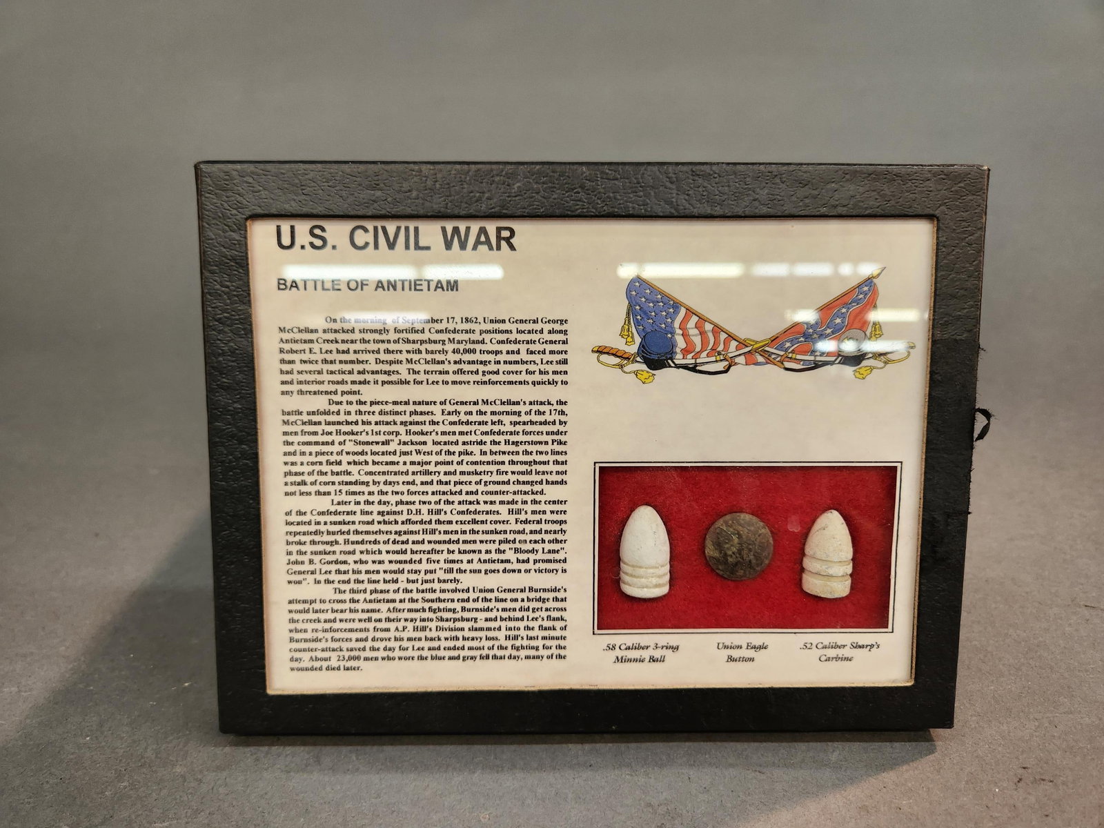 Civil War Battle of Antietam artifacts in case: A group of U.S. Civil War Battle of Antietam artifacts in case. Including Minnie ball, Sharp's carbine bullet, and Eagle button. 6 1/4" x 8 1/4"