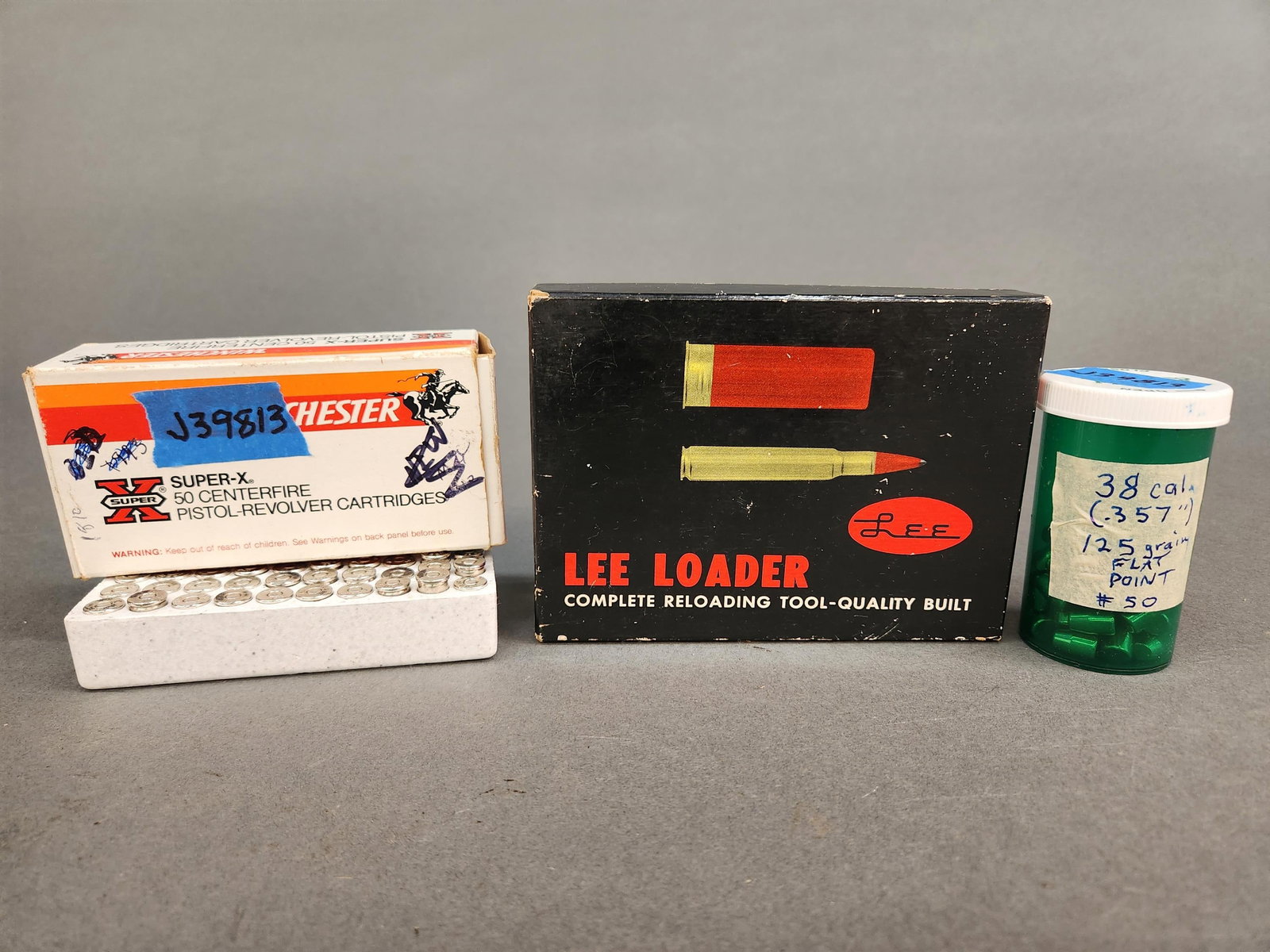 .38 S&W Lee Loader, primed cases, and bullets: A vintage .38 S&W Lee Loader, primed cases, and 125 grain flat point bullets