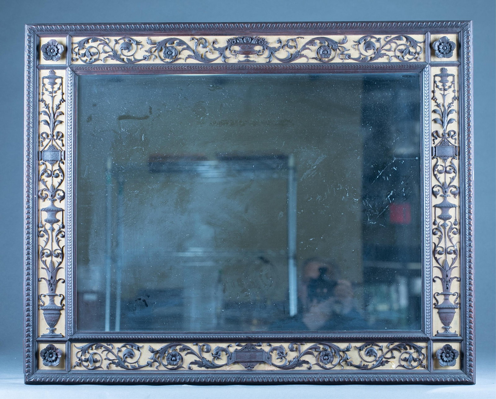 Renaissance Revival walnut mirror: A Renaissance Revival walnut mirror with applied wood scrolls and flowers around frame. Circa 1910. 28 1/2" x 35 1/4".