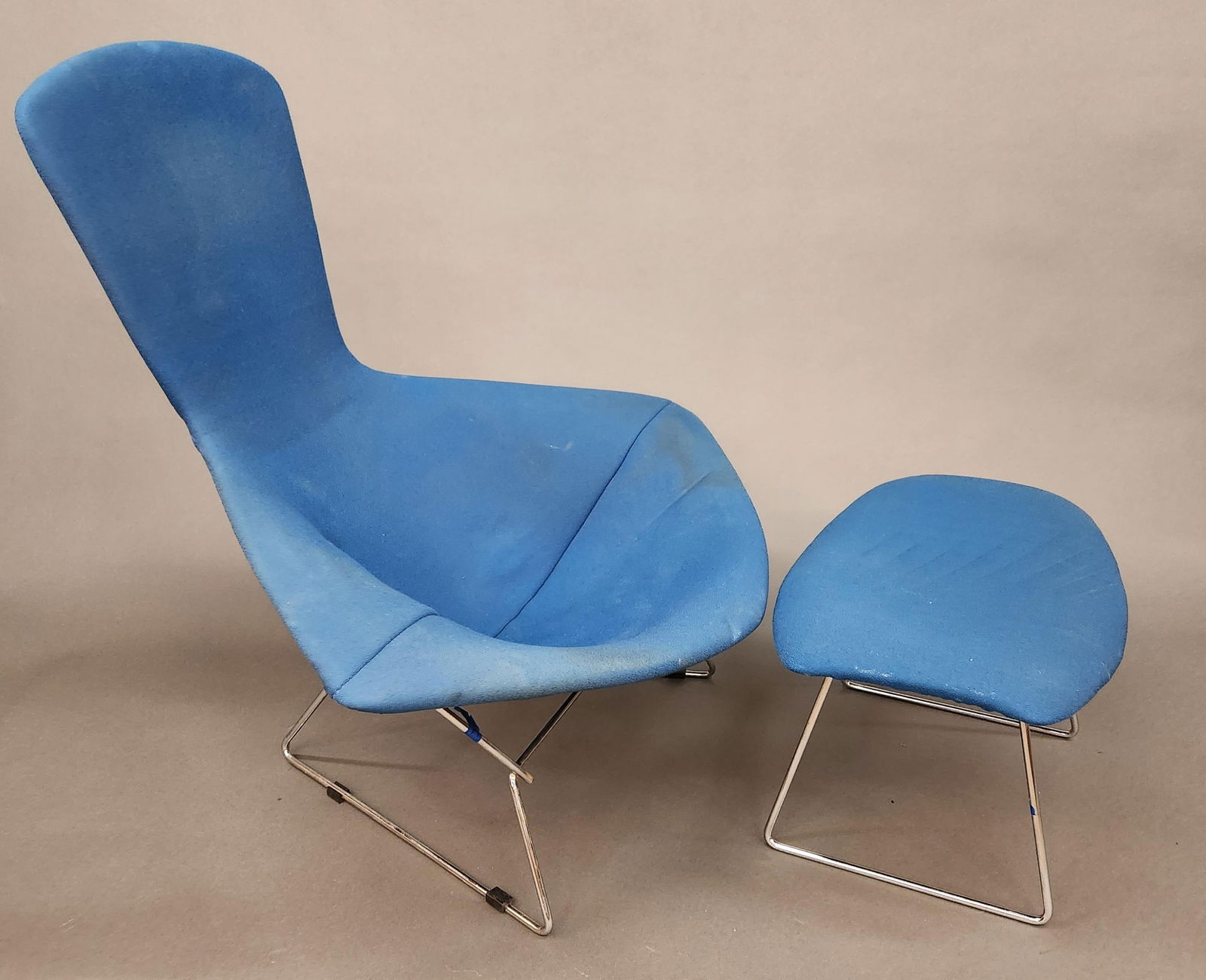 Harry Bertoia 'Bird' chair and ottoman: A Harry Bertoia 'Bird' chair and ottoman for Knoll. Blue fabric over chrome steel wire frame. 38 1/4" x 38" x 35" Ottoman:14 3/4" x 24" x 17"