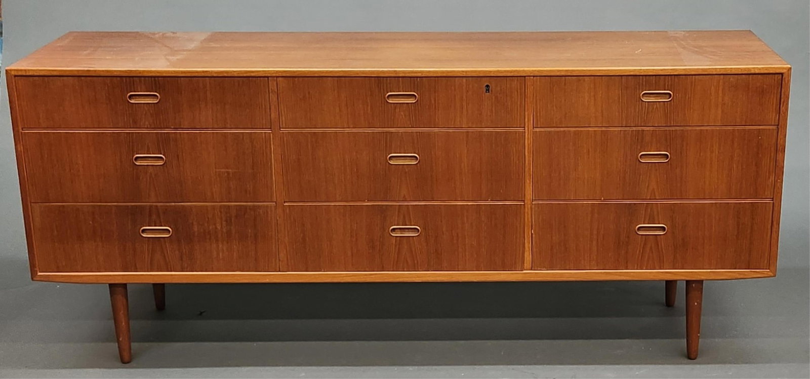Danish Modern Falster credenza: A Danish Modern Falster teak veneered nine drawer credenza. Falster label in drawer. 38 1/2" x 72" x 17 3/4"
