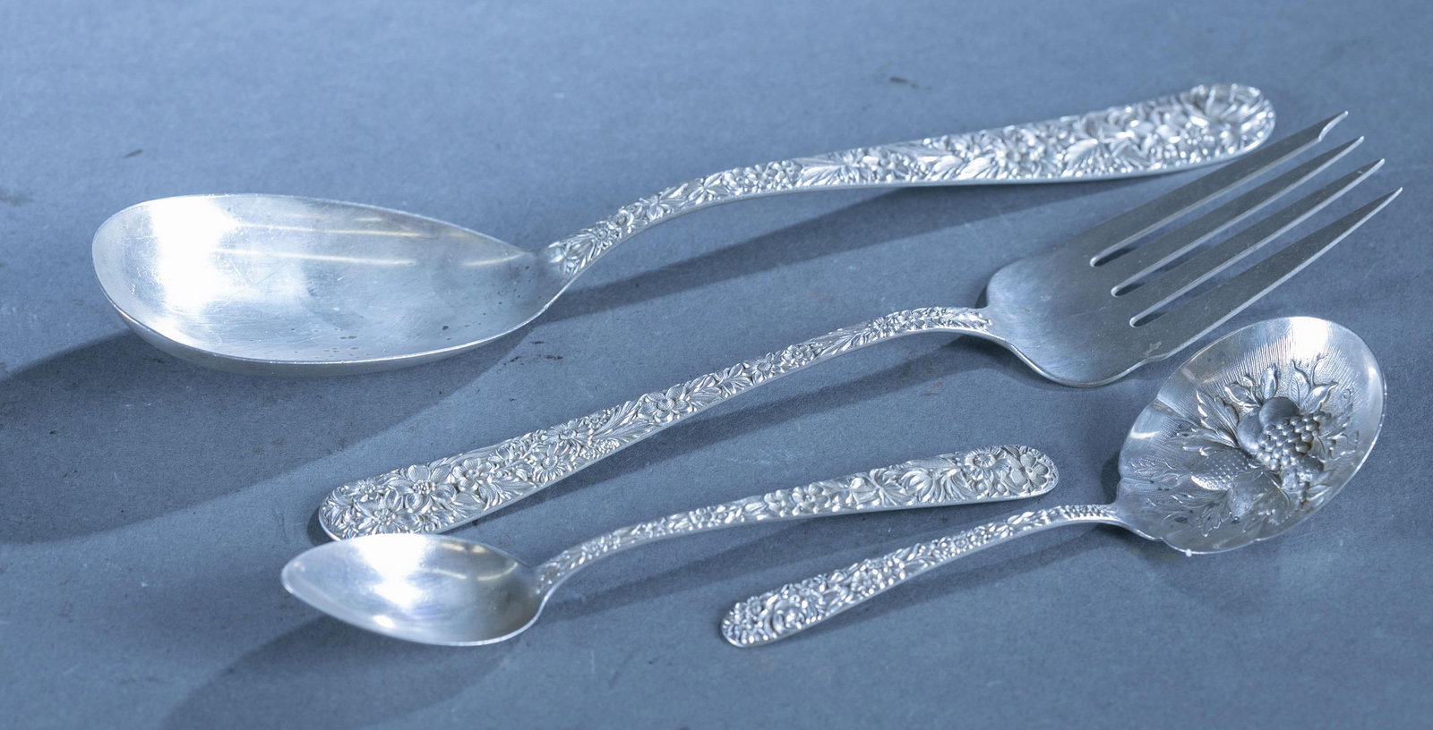 S. Kirk & Sons "Repousse" sterling flatware.: A group of S. Kirk & Sons "Repousse" pattern sterling flatware. Thirteen pieces. 15.84 ozt. Two monogrammed. Includes eleven 5 7/8" teaspoons, one 5 1/8" bon-bon spoon, one 9 6/8" serving spoons, and 
