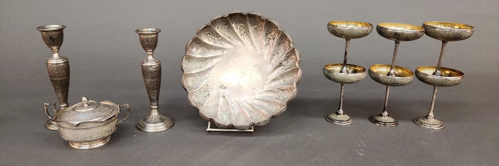 10 Persian silver pieces.: A group of ten Persian .875 silver pieces. 20th century. ++ Coupe glasses. Hallmarked on bottom and marked "Khosrow." 23.16 ozt. 4 3/4" x 3 1/2". ++ Lidded and sugar. Hallmarked on bottom. 3 1/2" x 6"