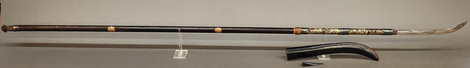 Japanese Edo Naginata.: A Japanese Edo Period Naginata. 15" blade with unsigned tang. 27" overall. Silver habaki. 80" mother of pearl and lacquer ebu staff with silvered bronze semegane rings. Iron ishizuki. Saya wooden scab