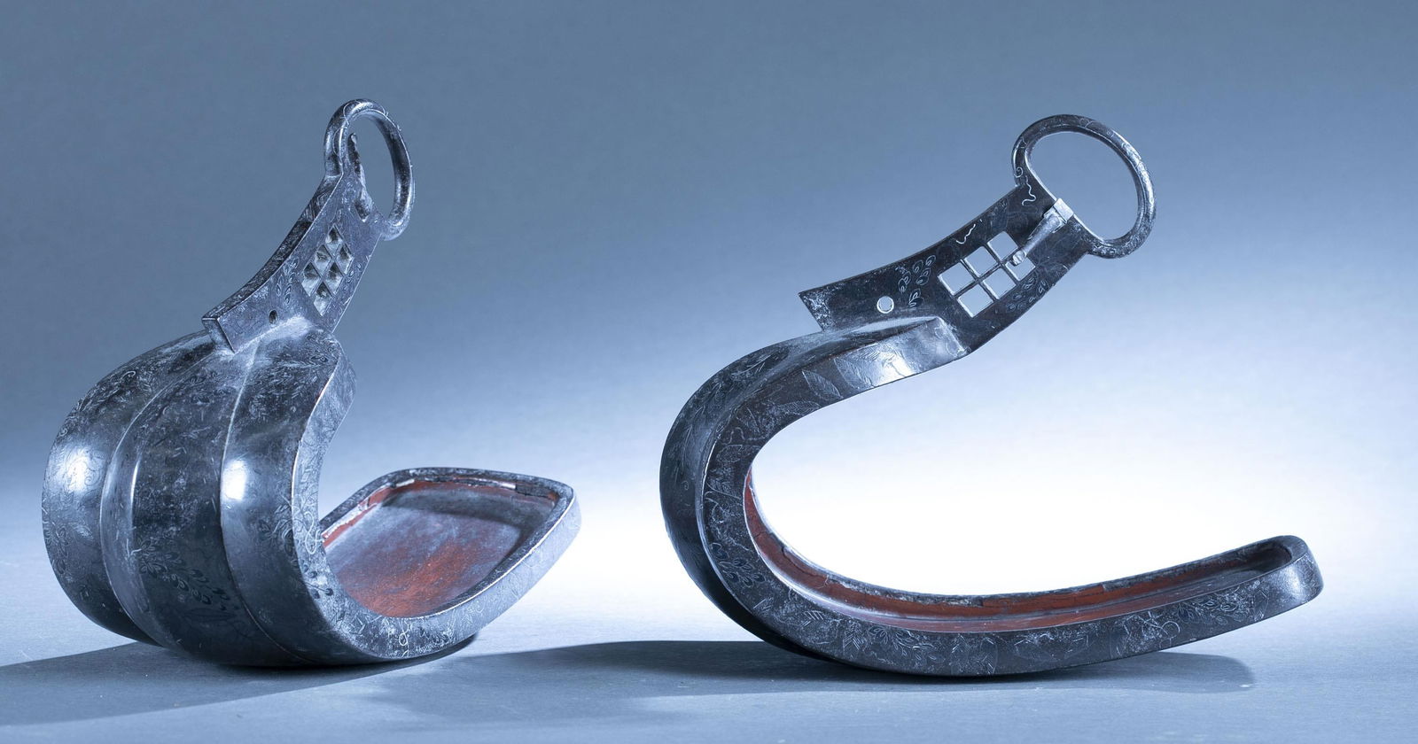 Japanese Edo Period abumi stirrups.: A pair of Japanese Edo Period abumi stirrups. Iron with floral silver inlay. Lacquered foot bed. 9 3/4" x 10 1/2" x 5 1/4".Cracking of lacquer.