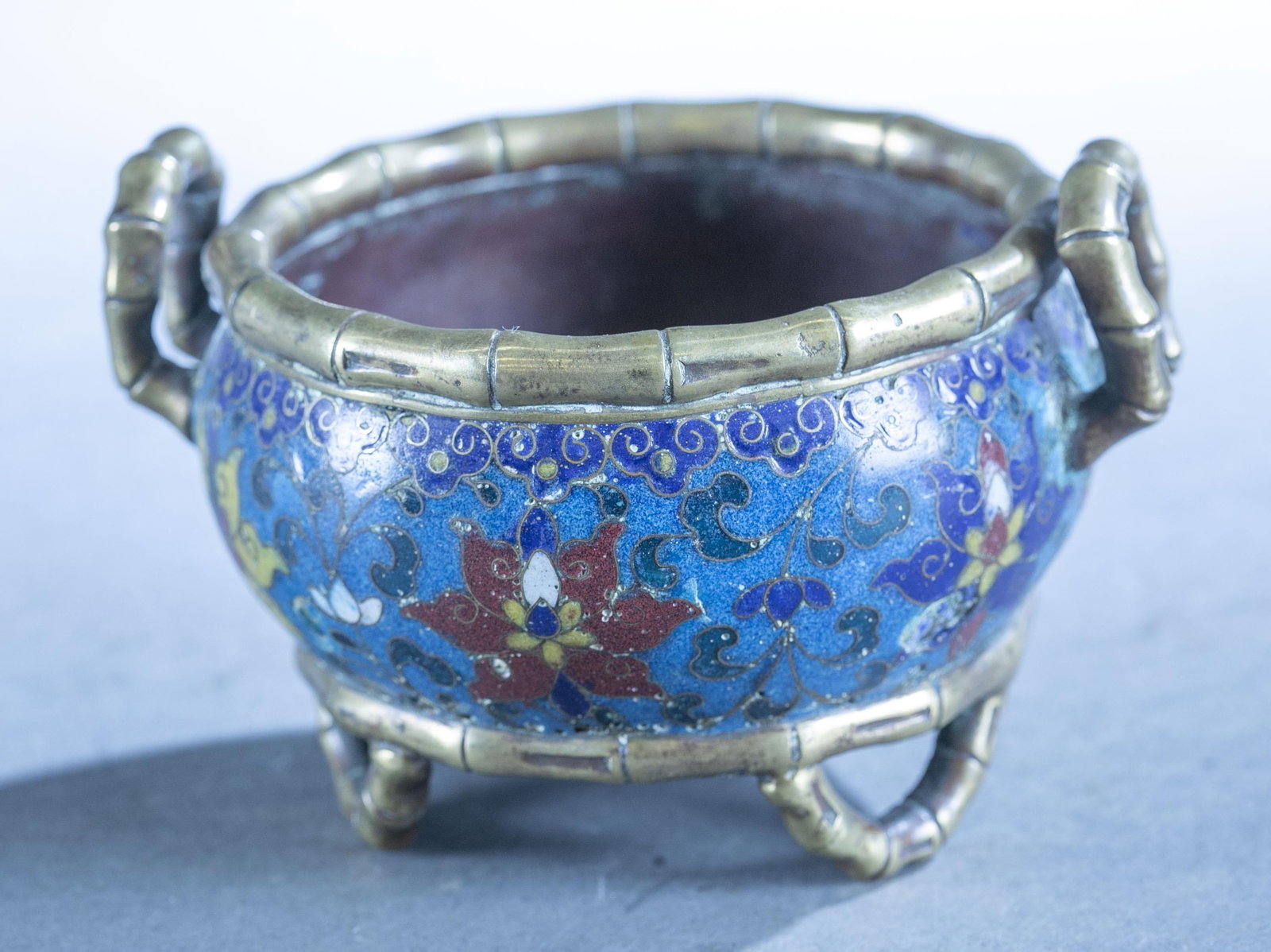 Chinese Nationalist Republic cloisonne bowl.: A Chinese Nationalist Republic cloisonne bowl. Circa 1925-1948. Bamboo form brass handles lip and feet. Crossed Nationalist flag on bottom. 3" x 4 1/2".