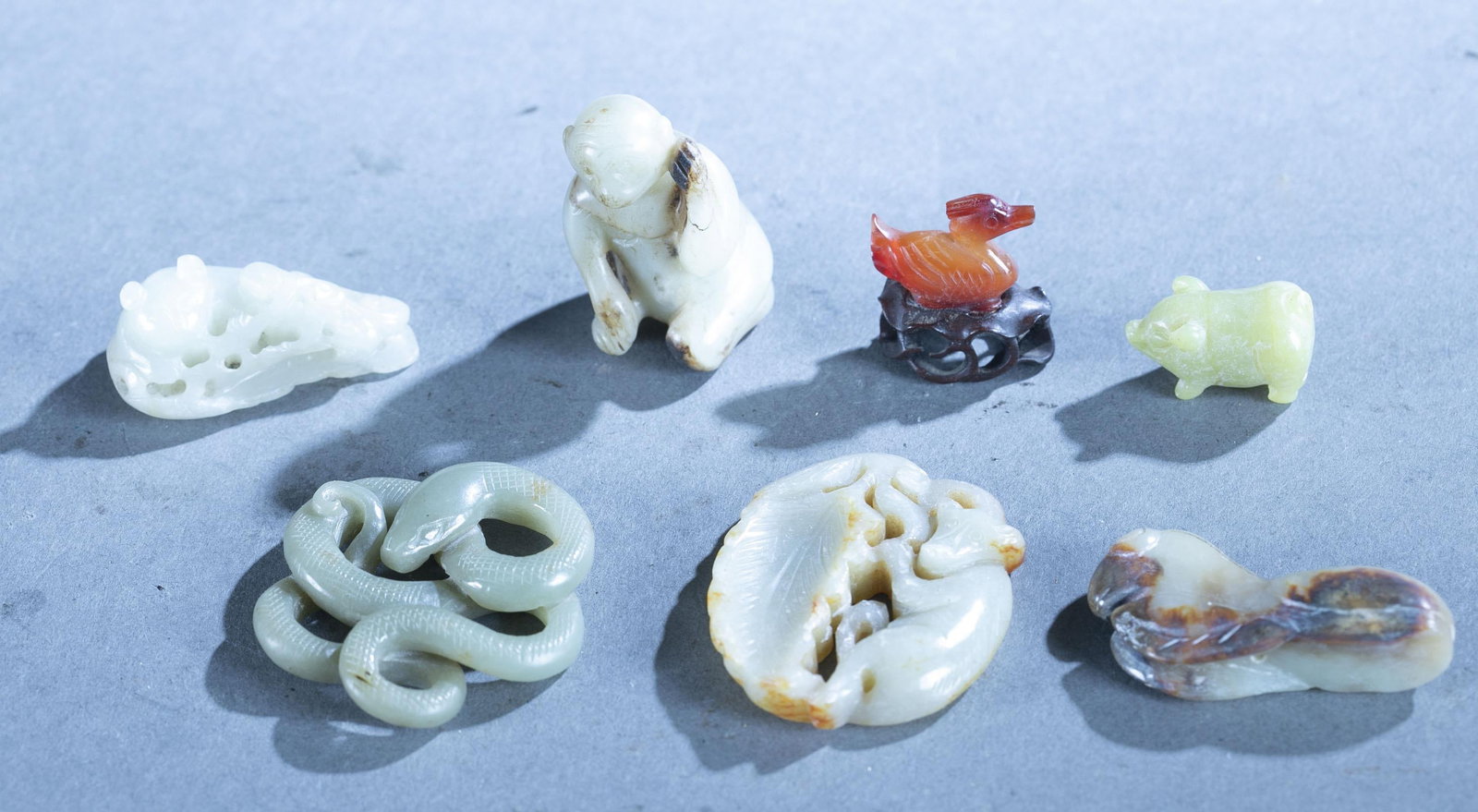 7 Carved jade and hardstone animal figures.: A group of seven carved jade and hardstone figures. Including jade monkey, duck and rodent figure. Largest: 2". Smallest: 3/4".