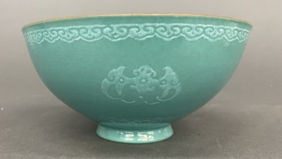 Chinese blue glaze bowl.: A Chinese blue glaze porcelain bowl with bat design. Early to mid 20th century. Turquoise blue glaze with white glaze design of four large bats and lingzhi near the gold rim. Bottom goes to a point wi