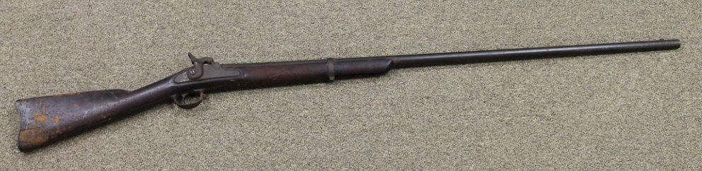 Cut Down Model 1861 US Flintlock Musket Converted: Rifled musket. Marked "US Springfield". The stock has been cut back to 5" in front of the first band. 56" long. From the estate of Joan Rose. Previously owned by "Poppop" Nightingale, Montross, Virgin