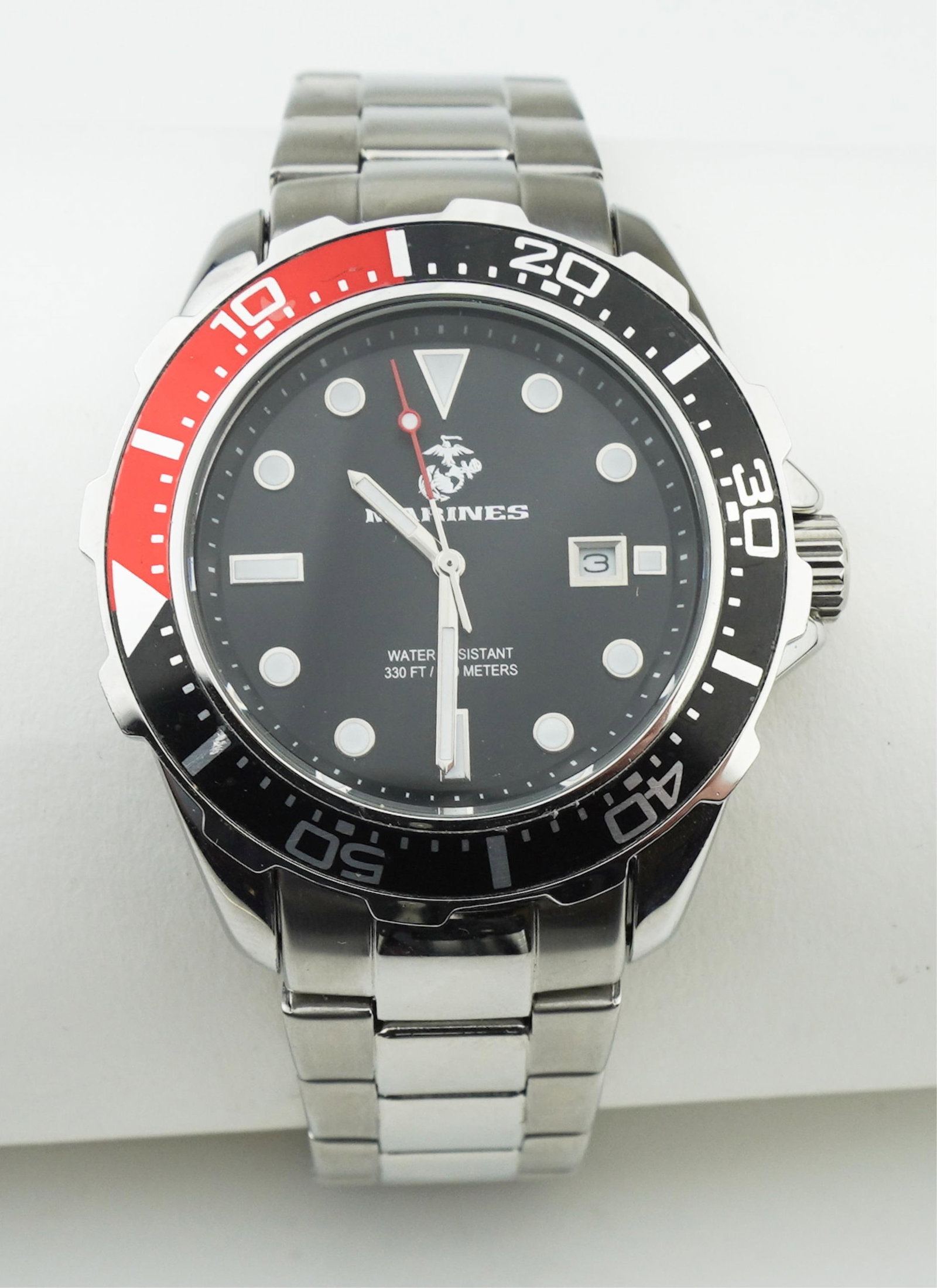 Stainless Steel Marine Corps Watch: A Stainless Steel Marine Corps Watch by WRIST ARMOR, stainless steel approx. 45.0mm case, stainless steel link bracelet with depolyant clasp, uni-directional bezel in black and red, black dial with lu