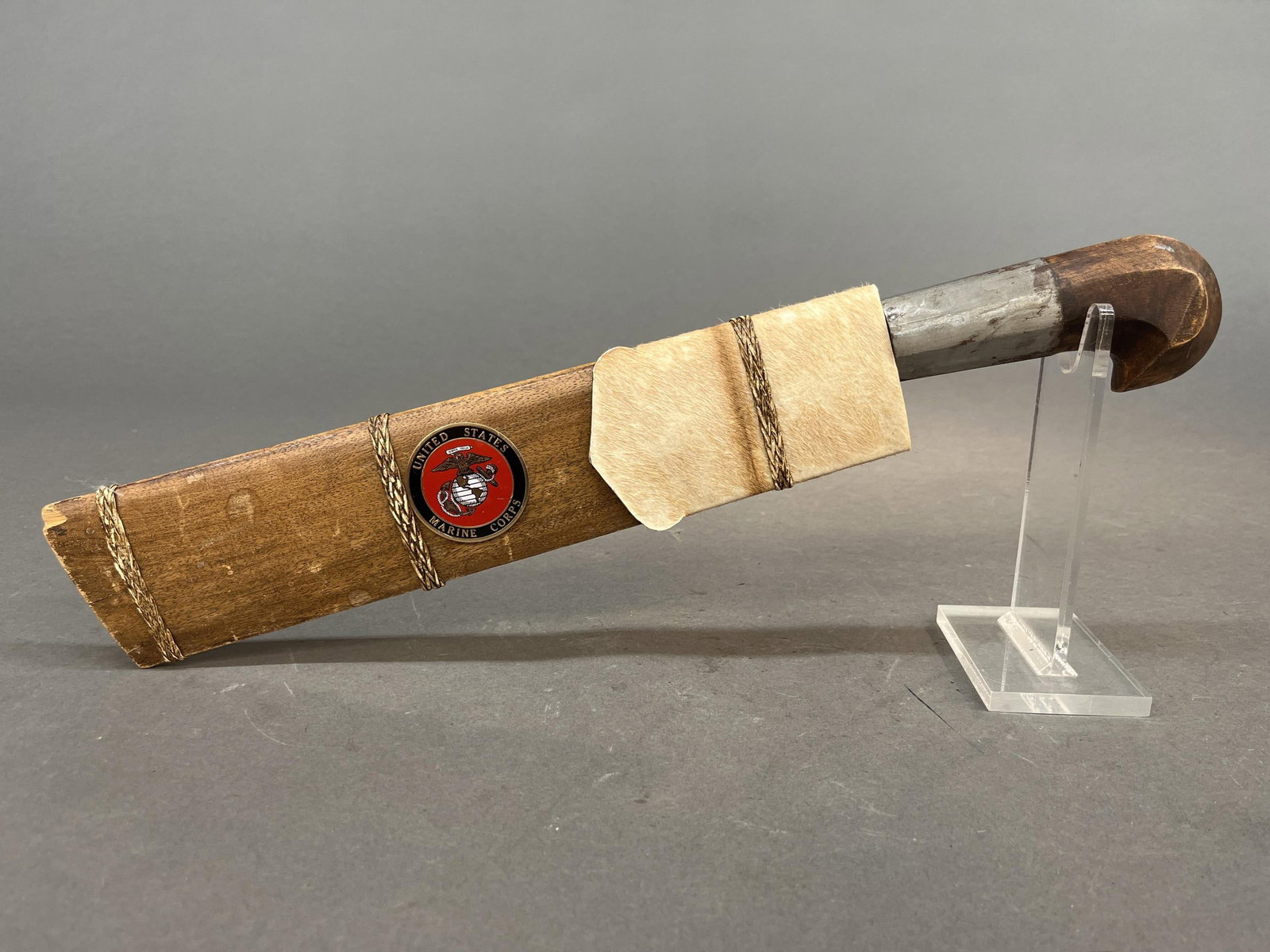 Gen. Gray Indonesian Golok machete: A General Alfred M. Gray Jr. Indonesian Golok machete with scabbard. 13" blade engraved "TO GENERAL A.M. GRAY/ THANK YOU/ 2nd Lt. G.D. GAJE JR./ DECEMBER 19, 1997." Wood and hide scabbard has metal U.