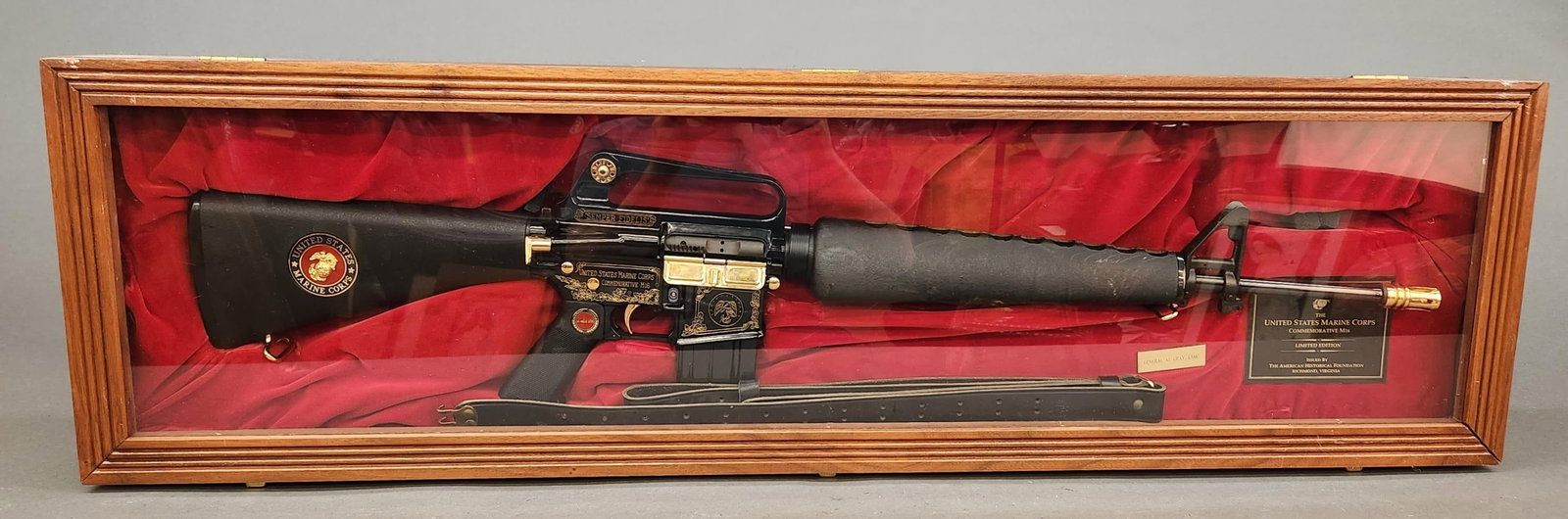 AHF Bushman XM15-E2S USMC M16 rifle, 223-5.56mm: A cased American Historical Foundation Bushmaster XM15-E2S limited edition U.S. Marine Corps Commemorative M16 rifle, 223-5.56mm. Gold washed and gloss black finish. 20" barrel. Early M16 plastic comp