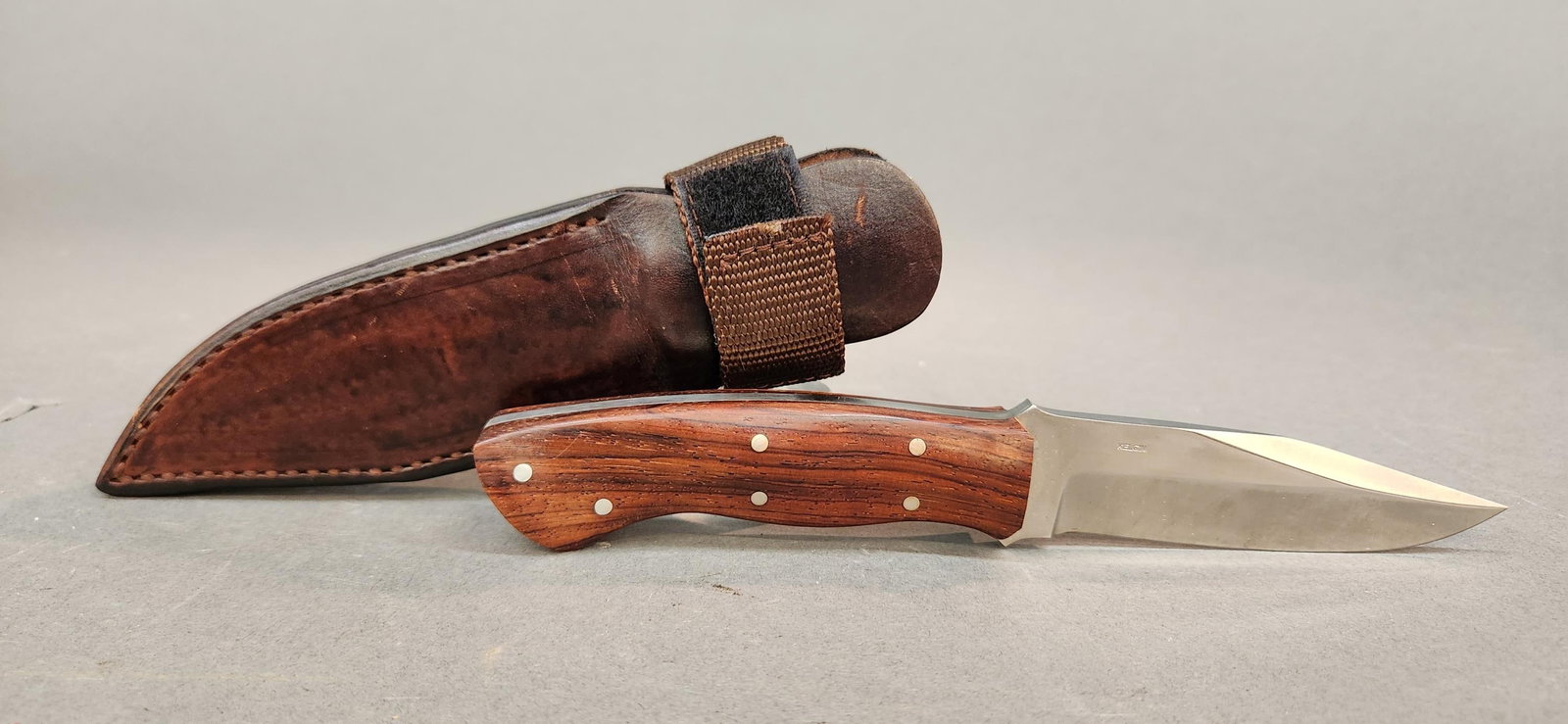 Kelgin Knives Desert Storm Utility Knife: A Ken Largin "Kelgin Knives" Desert Storm Utility fixed blade knife . 4 1/4" clip point blade. Marked "KELGIN" and "Desert Storm U.S.A." Walnut handle. Includes leather sheath with boot clip. 8 5/8" o