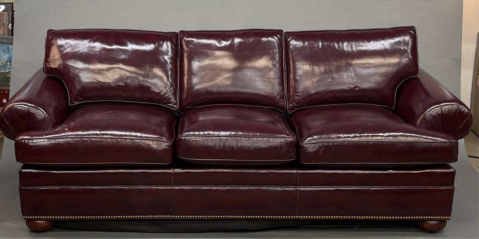 Leather sleeper sofa: A red leather three seat sleeper sofa. 29 1/2" x 84" x 34". Provenance: From the estate of U.S.M.C. Four Star General Alfred M. Gray Jr (American, 1928-2024). General Gray was the 29th Commandant of t