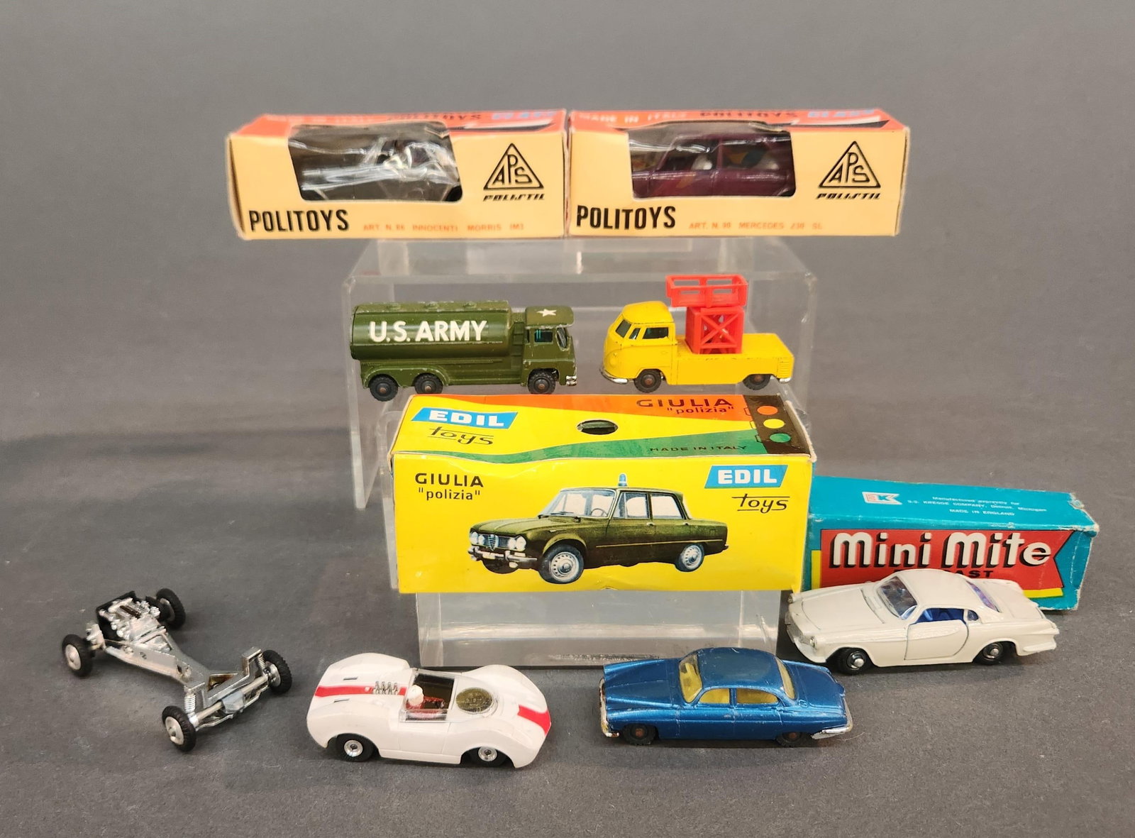 8 Diecast cars: A group of eight diecast cars. ++ Politoys in box 86 Innocenti Morris IM3 and 90 Mercedes 230 SL. ++ Edil 5 Giulia "Polizia." ++ Mini Mite No. 19 Volvo 1800 S in box.