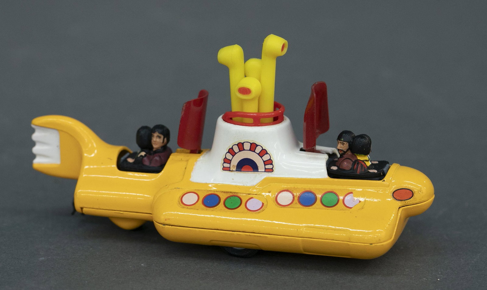 Corgi Toys #803 The Beatles Yellow Submarine: A Corgi Toys #803 The Beatles Yellow Submarine, 1969-1972. Red covers with figures and turning periscopes in working condition. 2 3/4" x 5 1/4" x 2 1/4" Condition: Some loss of decals, staining and pa