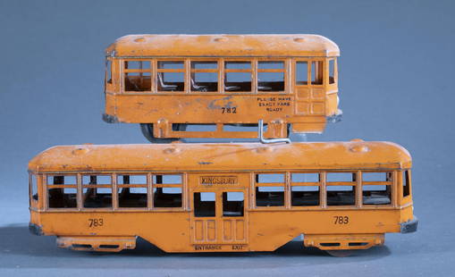 2 Kingsbury Mfg Co. pressed steel wind up trolleys: A group of two Kingsbury Manufacturing Co., NH pressed steel wind up No. 782 and 783. 4" x 9 1/2" x 3 6/8" and 14" x 5" x 3 1/2" Condition: Loss of paint. Oxidation. Both are in working condition. 783