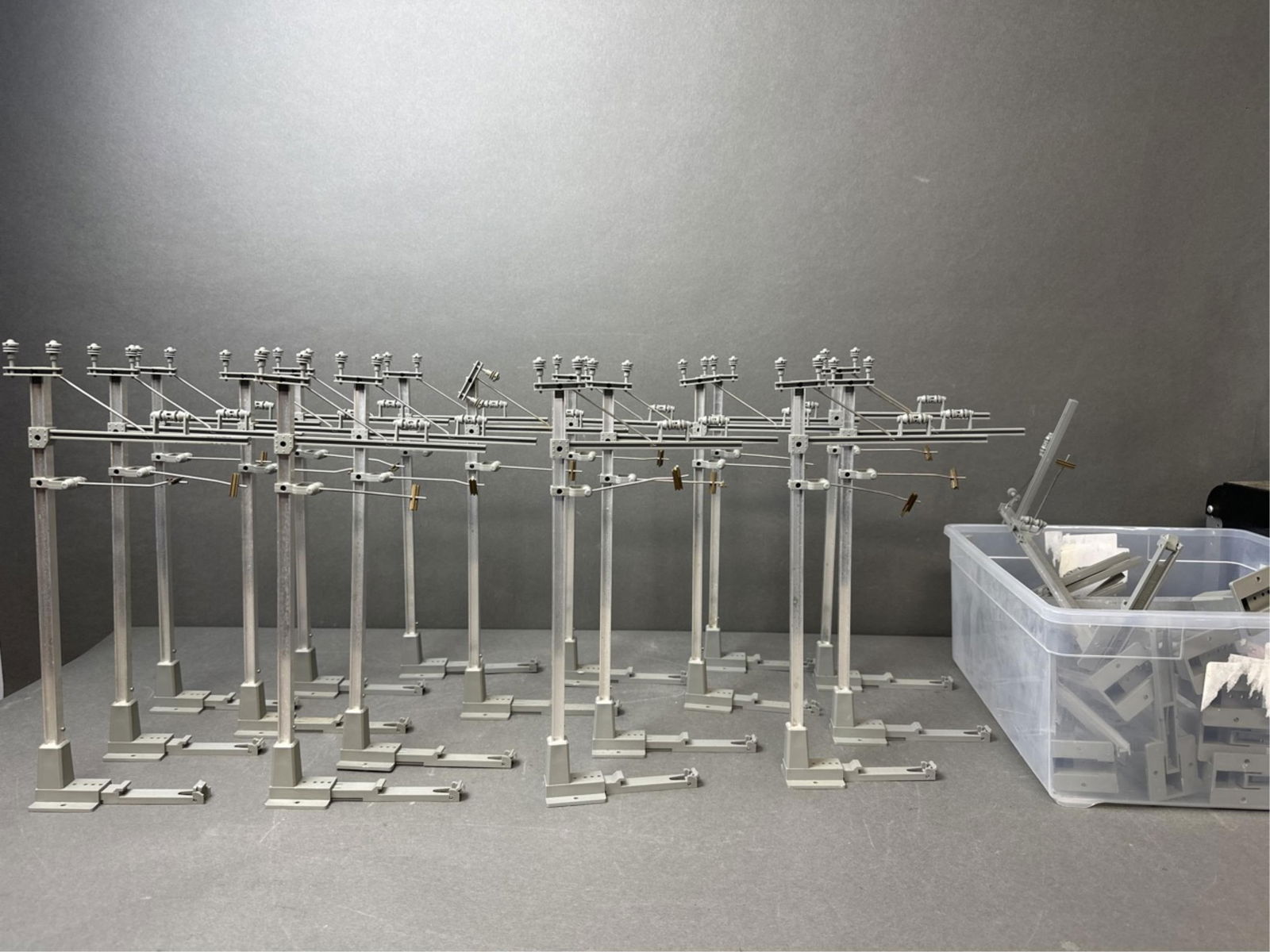 29 LGB G Scale No. 5630 Catenary Masts: A group of twenty-nine LGB G Scale No. 5630 Catenary Masts. 17 complete masts and 12 masts that are incomplete/ have broken pieces. 6" x 1 3/4" x 14"
