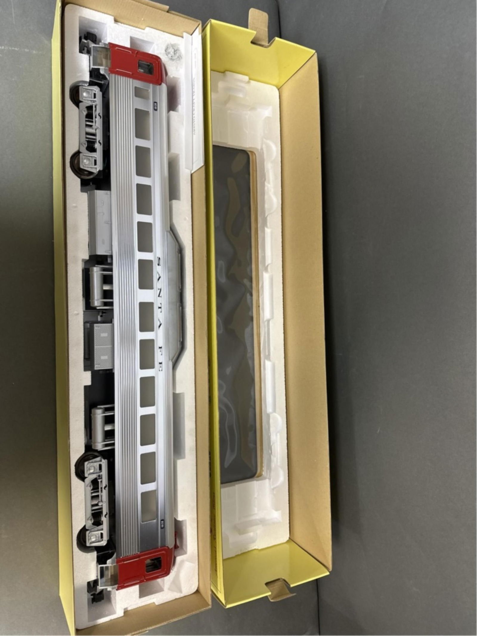 Aristo Craft G Scale ATSF Diesel Car in box: An Aristo Craft Santa Fe No. 22810 Rail Diesel Car in box. 6 1/2" x 31" x 4" Condition: One window needs repair and is swinging in the door