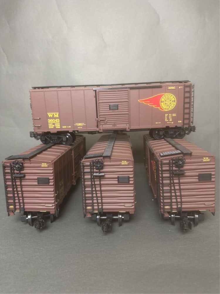 4 Aristo Craft G Scale No. 46094 boxcars: A group of four Aristo Craft (Railway Express Agency) G Scale No. 46094 Western Maryland 40' steel boxcars. Car numbers are all 36043. 6" x 17" x 4" Condition: One car has broken plastic pieces on sli