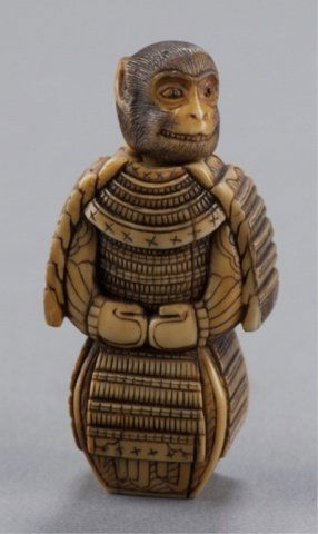 An ivory netsuke of a monkey in a suit of armor.: By Ikkosai Toun (1805-1876), Tokyo, Mid 19th century. , Mid 19th century. Representing the story of Hideyoshi Toyatomi, the "monkey-faced servant" (Saru-men Kwanja) who was sent by his master, Yukitsu